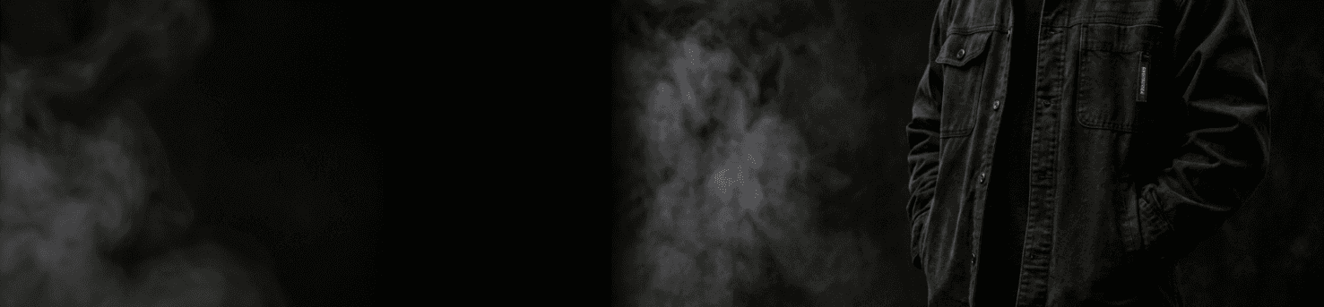 A heavyweight overshirt worn against black, lit through smoke